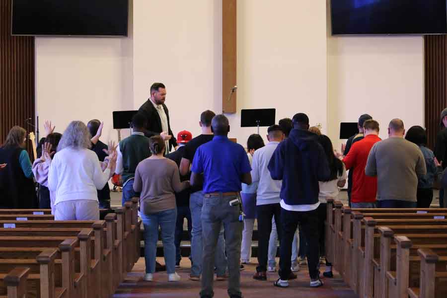 The church family gathered at the front in worship and prayer